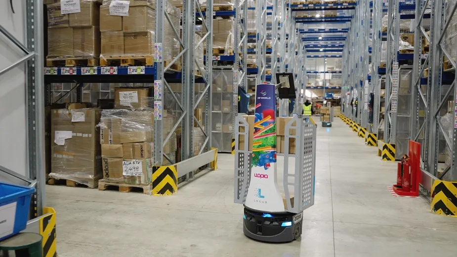 Autonomous warehouse robot navigating racked aisles — innovative logistics technology in action